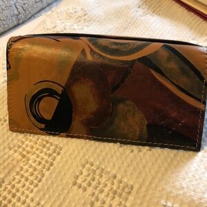 A Ladies’ “Patricia Nash” 100% full-grain leather lightweight wallet.